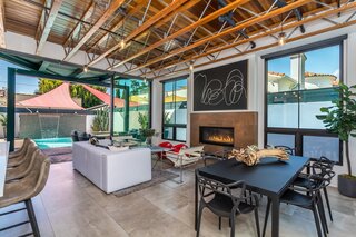 On the main floor, La Cantina sliding glass doors stretch across the entire rear wall, fostering seamless indoor/outdoor flow between the living areas and backyard.