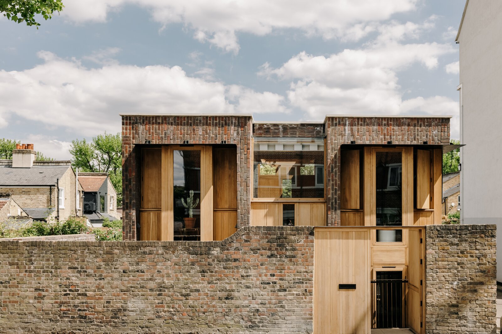 Two of the home's three levels rise from the site's original garden wall, presenting an impressive elevation from the street.