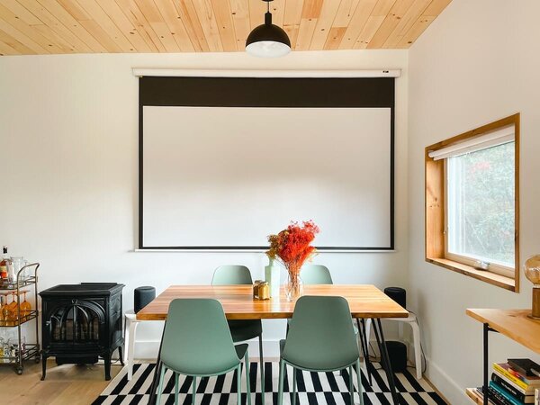 A gas fireplace heats the dining area, which doubles as a movie projection area.