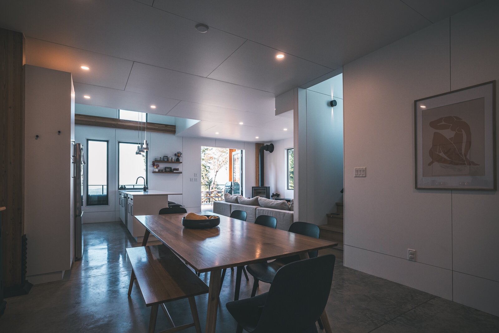 Made from MDF and finished-grade plywood, the wall panels are fabricated by Blend Projects at their workshop in Nanaimo, BC. The aluminum-framed windows from Pella are placed to enhance cross ventilation through the home. As seen in the kitchen, skylights and clerestory glazing are added wherever possible.