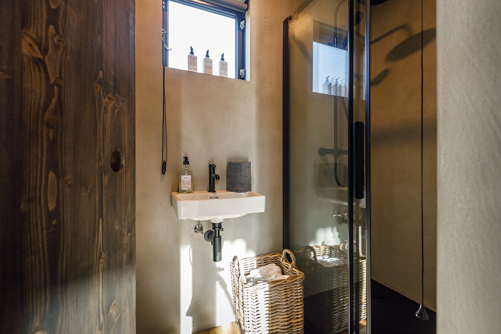 The bathroom walls (and floors in some models) are layered in Contec: a Danish material used to create concrete surfaces.