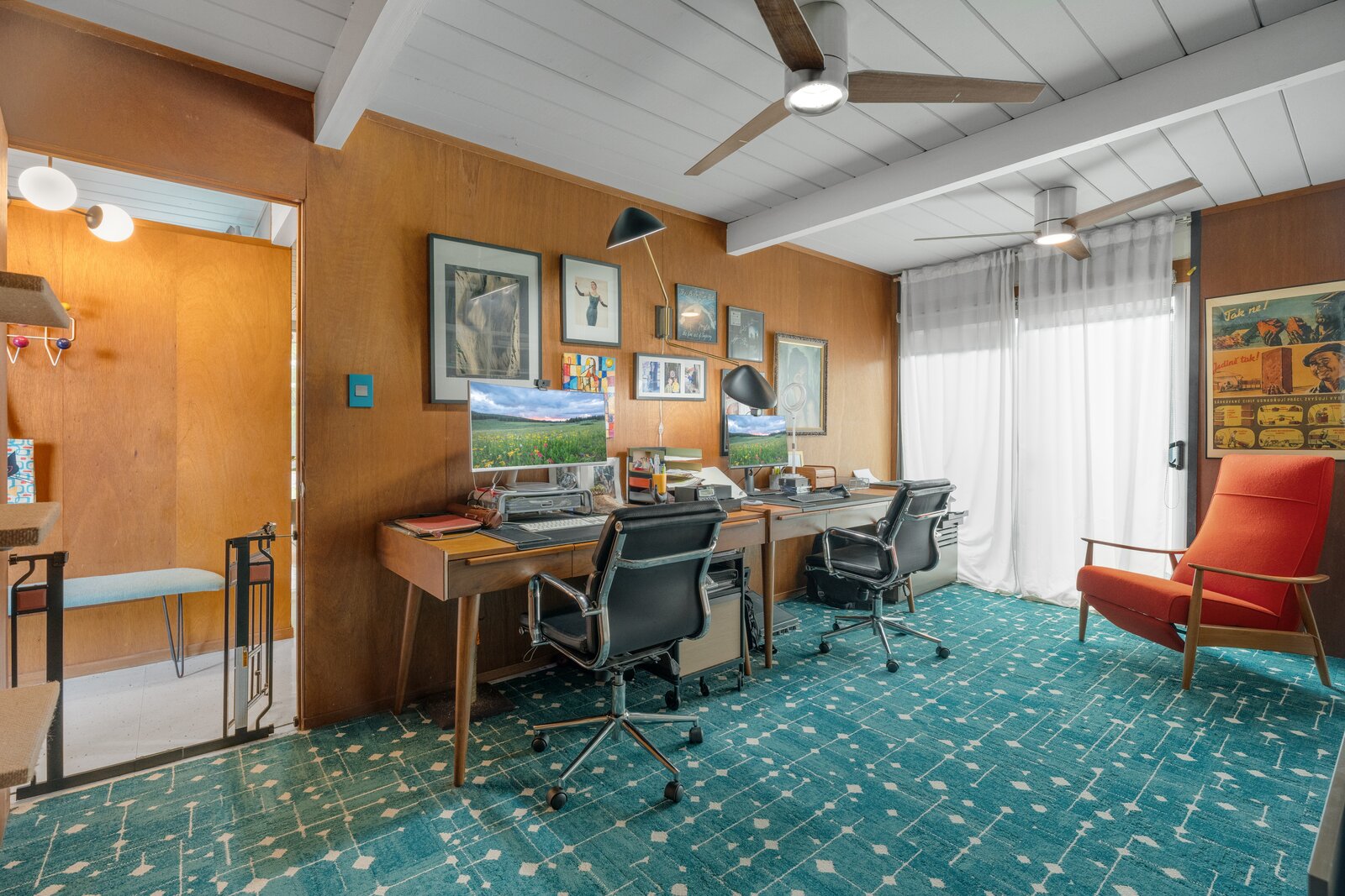 A wood-paneled bonus room presents a quiet corner for any working-from-home needs.