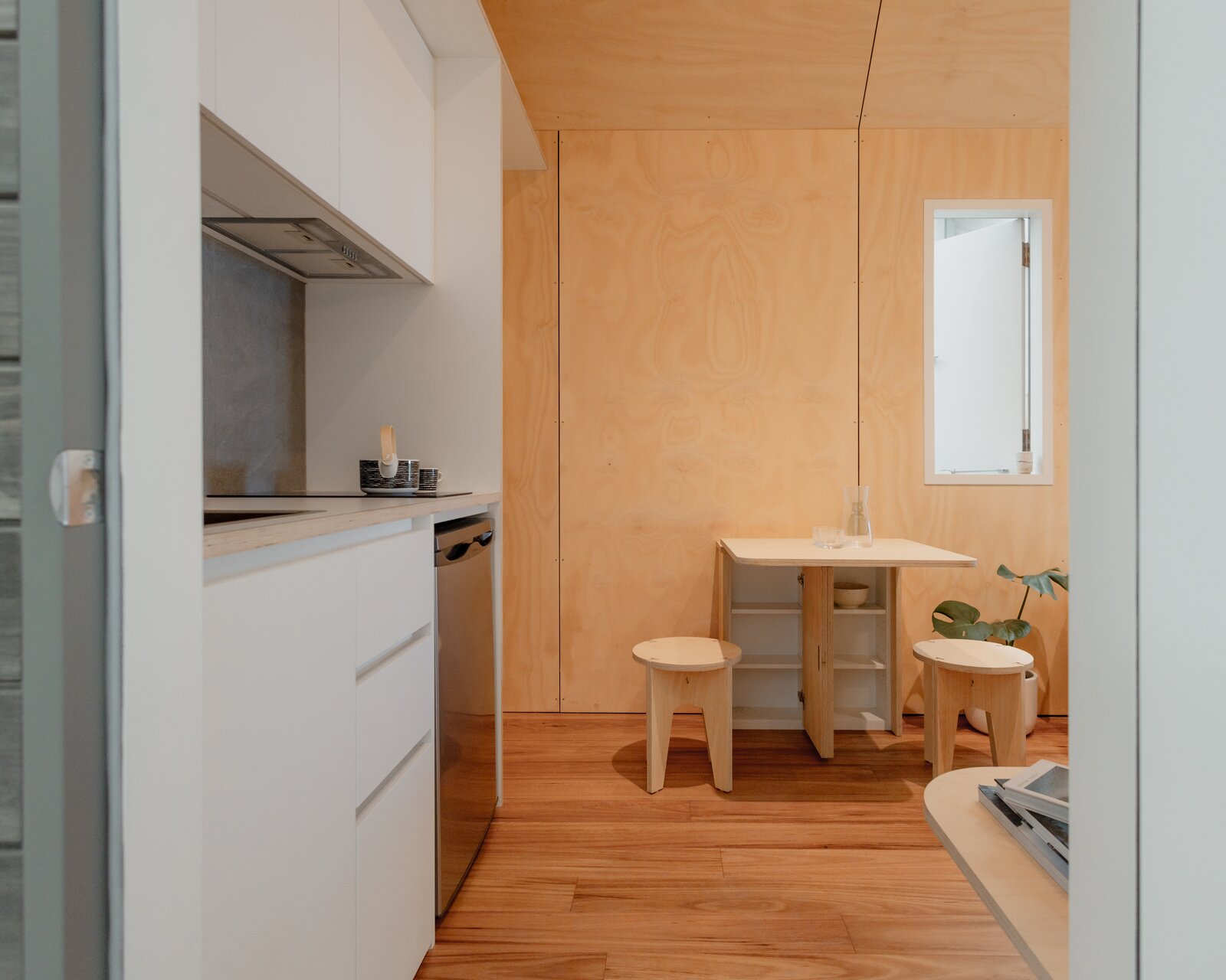 The walls and ceilings are cladded in A grade plywood, and the floors in the main room are paneled in medium-toned engineered hardwood.