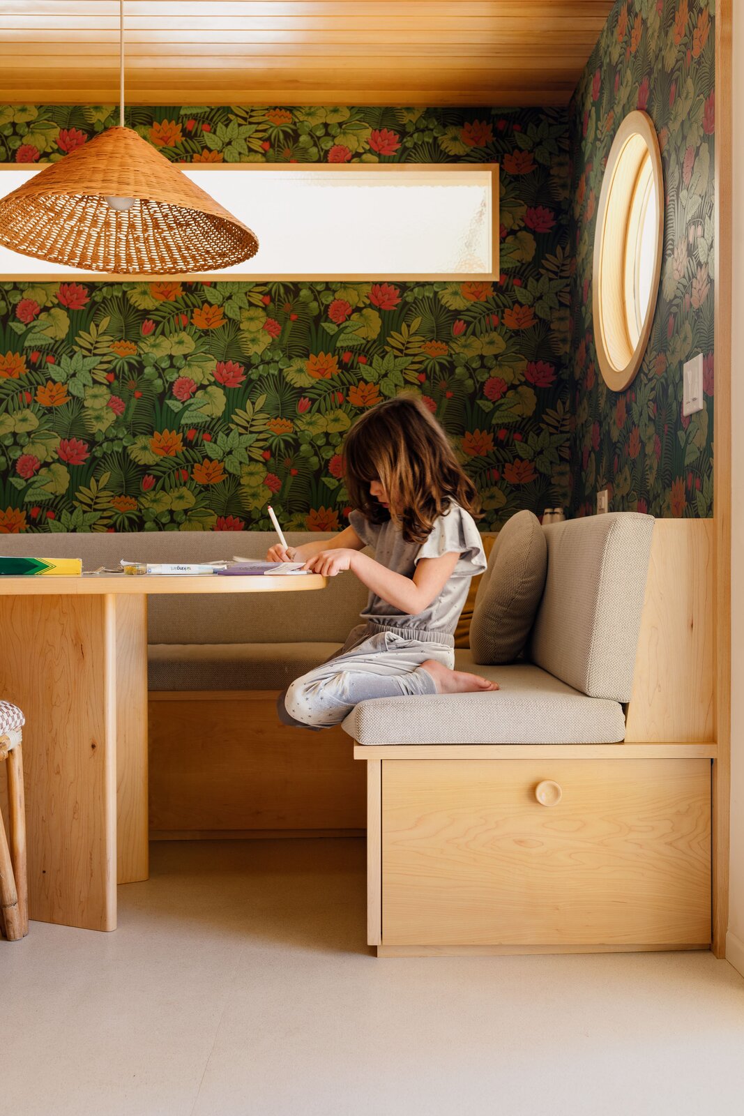 The round window brings in a bit of daylight into the breakfast nook—all the better to illuminate the rich tones of the wallpaper from Little Greene. 