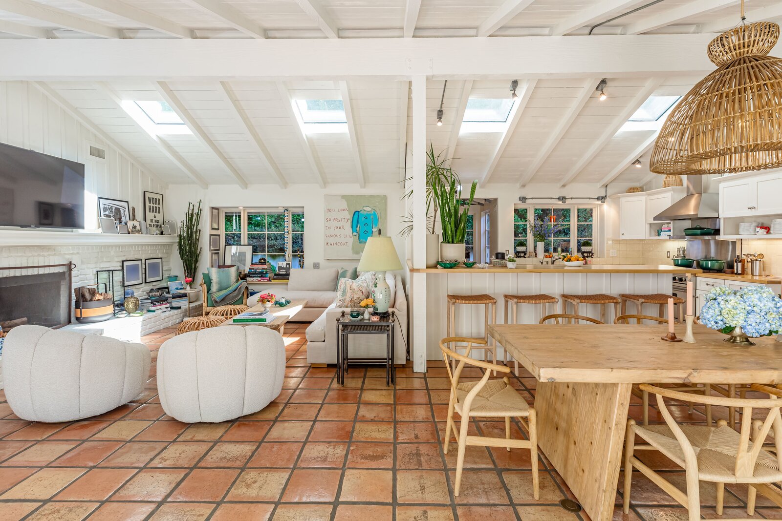 Skylights puncture the vaulted ceilings, infusing the main living spaces with an abundance of warm, natural light.