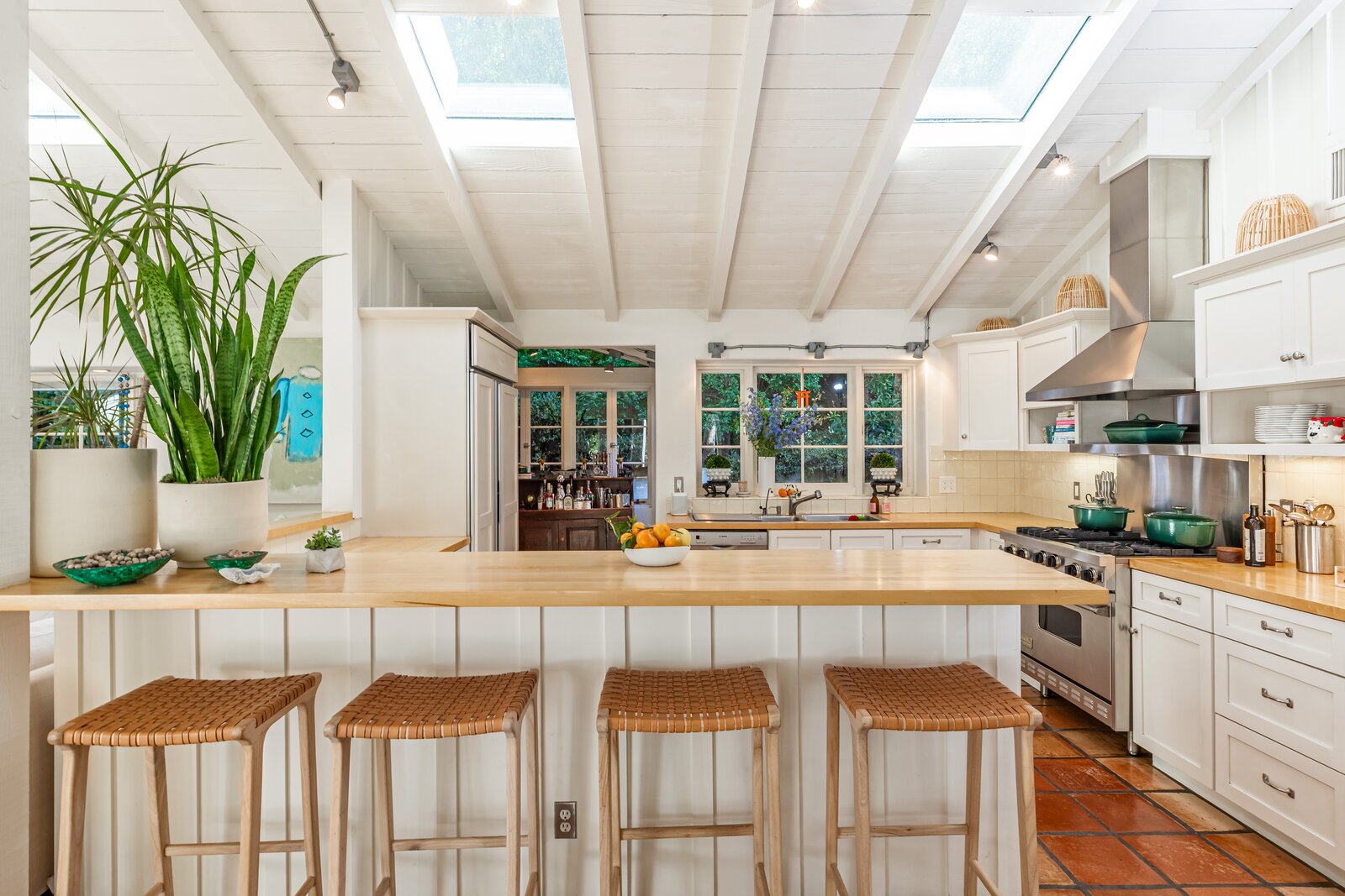 The remodeled kitchen is anchored by a large L-shaped island and fitted with custom cabinetry and top-of-the-line appliances.