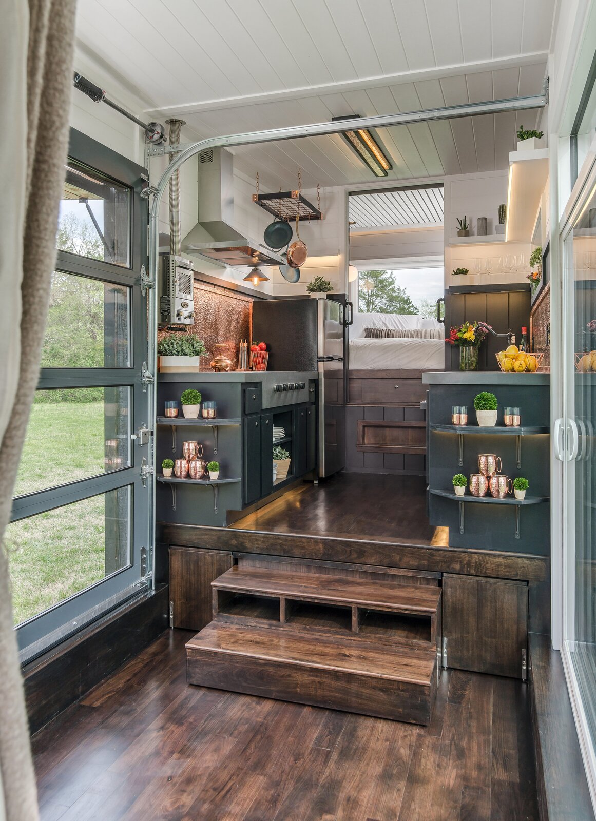 The price tag of $235K also buys a premium kitchen outfitted with quartz countertops, a copper backsplash, custom cabinetry, and appliances like an oven and four-burner propane stove from Furrion, a Fisher Paykel dishwasher, and a stainless-steel refrigerator from Whirlpool.