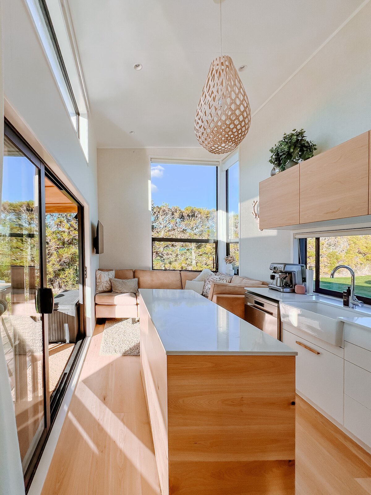 The home features three bedrooms. The largest sits at one end of the ground floor past the bathroom and a staircase that leads to the two bedrooms above it.