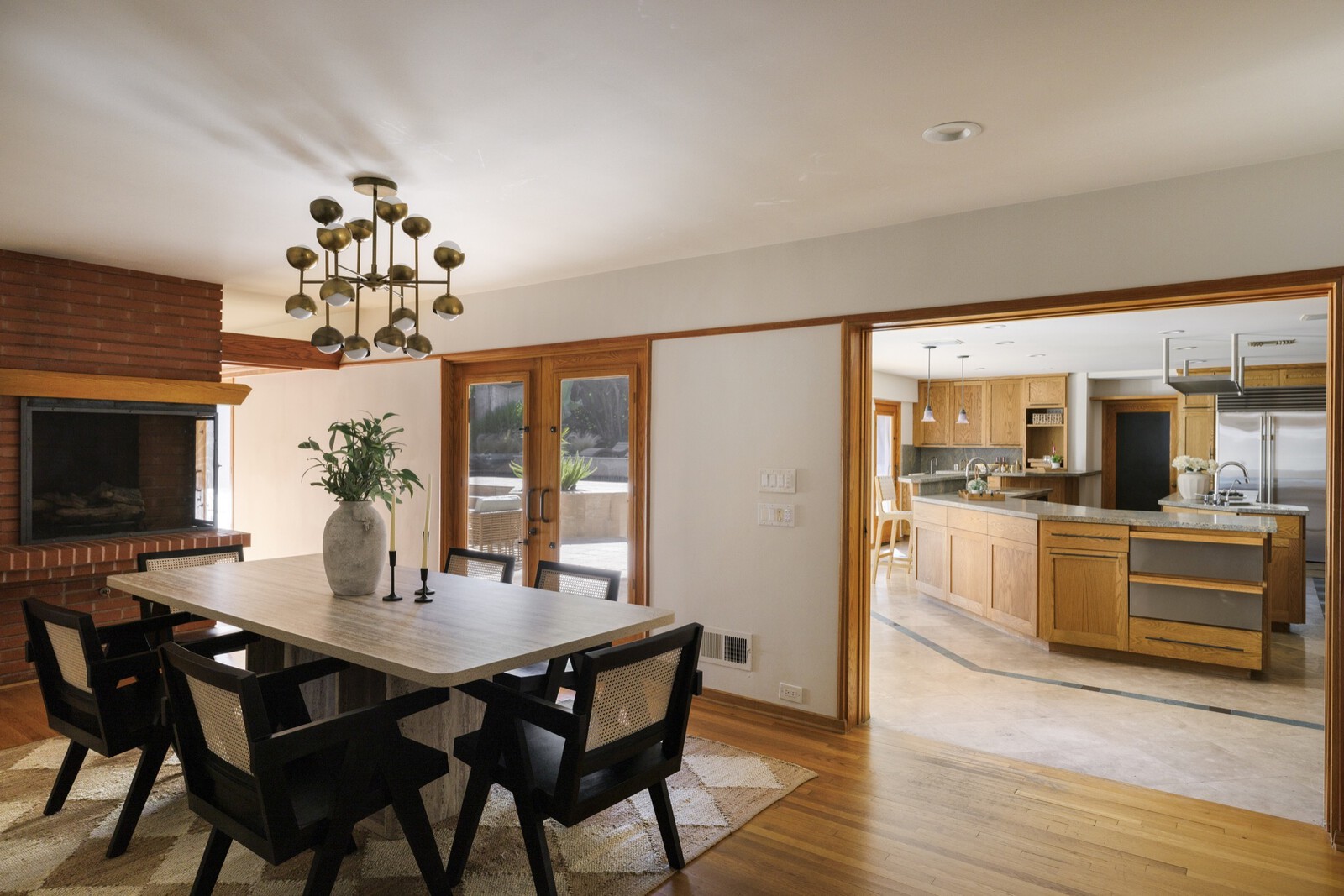 An original brick fireplace anchors the dining area set between the living room and kitchen.