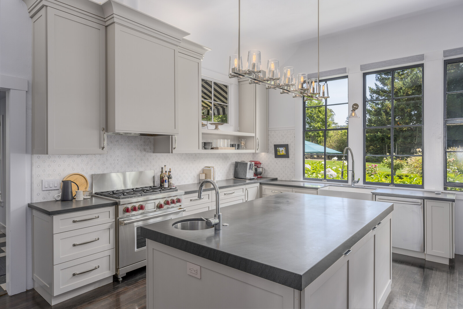 The bright and airy chef's kitchen overlooking the backyard is fitted with a central island, as well as high-end appliances, including a Sub-Zero refrigerator and Wolf six-burner range.