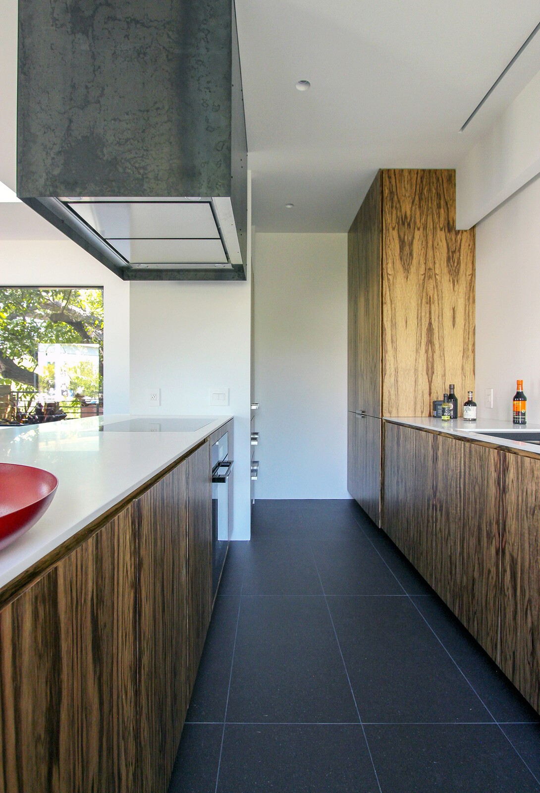 The Galley-style kitchen has custom wood cabinetry.