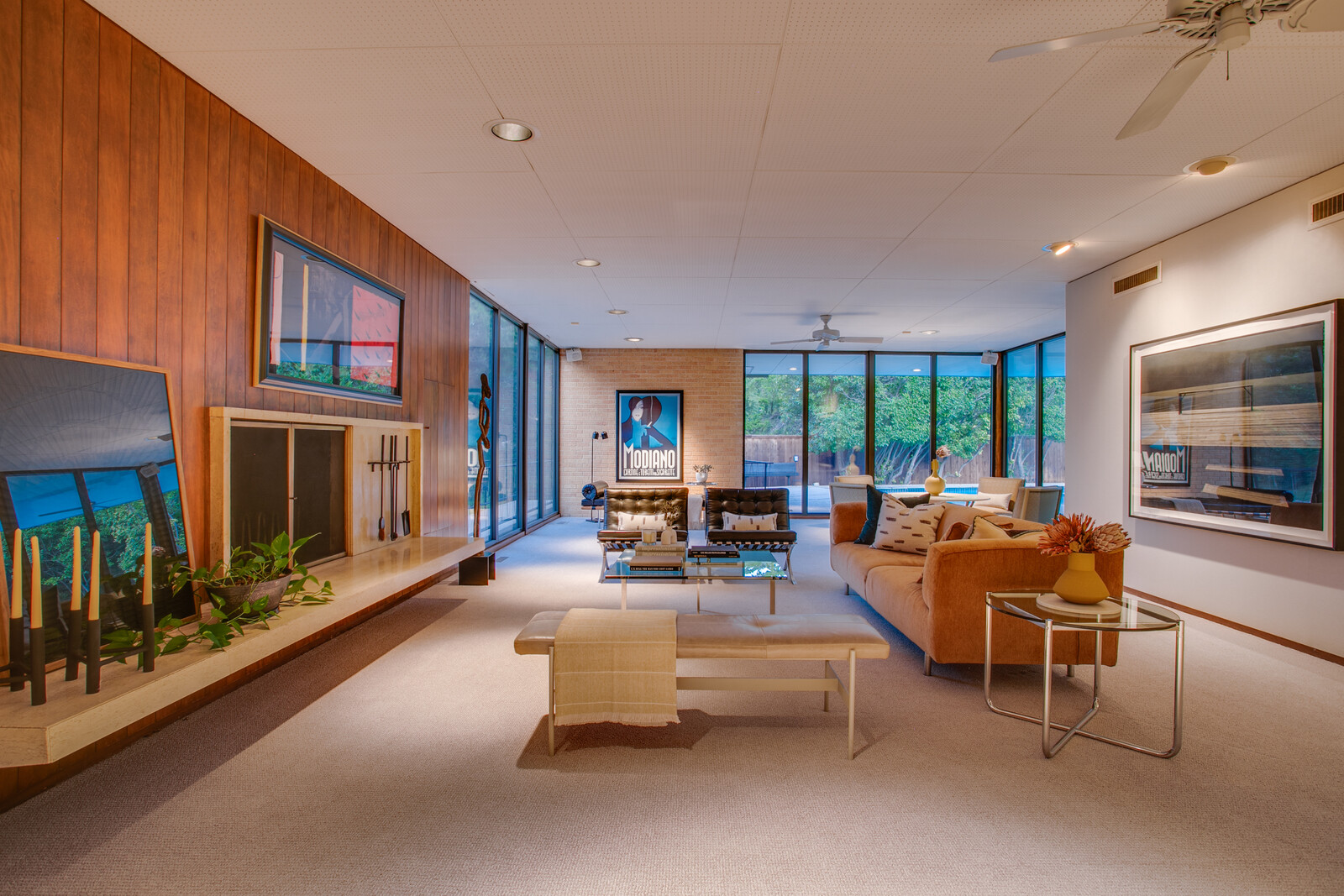 Original walnut paneling and travertine floors line the expansive main living room.
