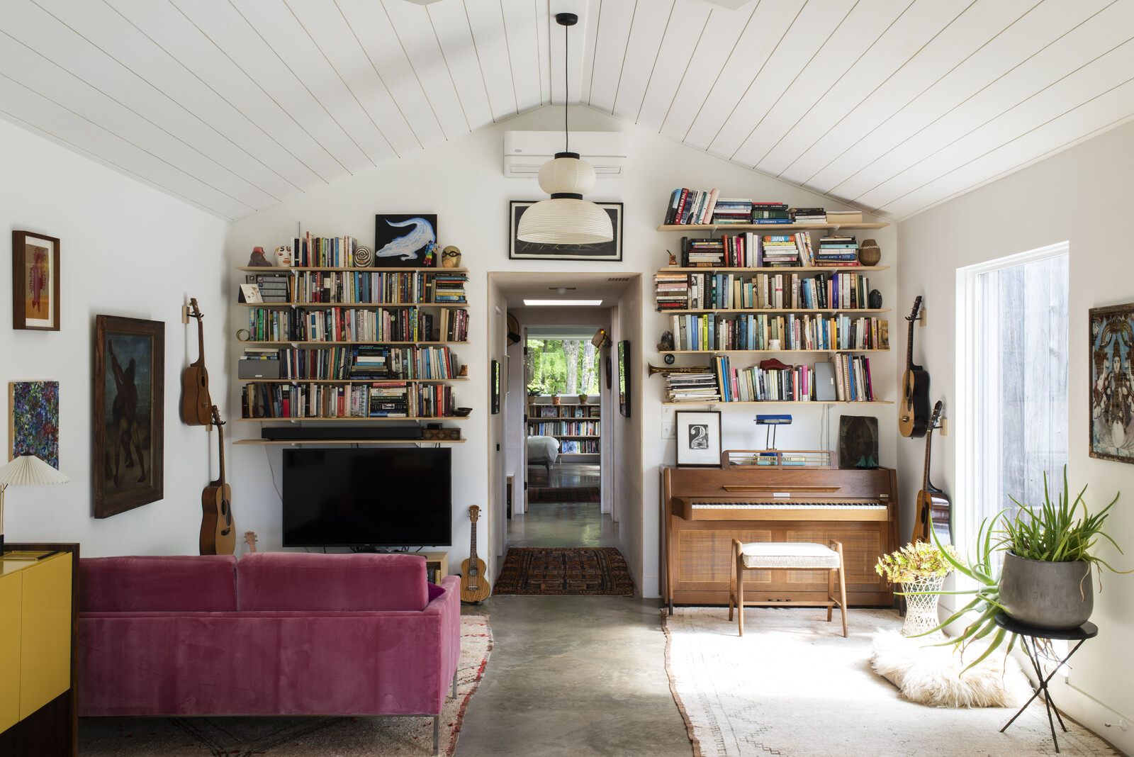 Polished concrete floors continue into the living room/library, where vaulted ceilings await.