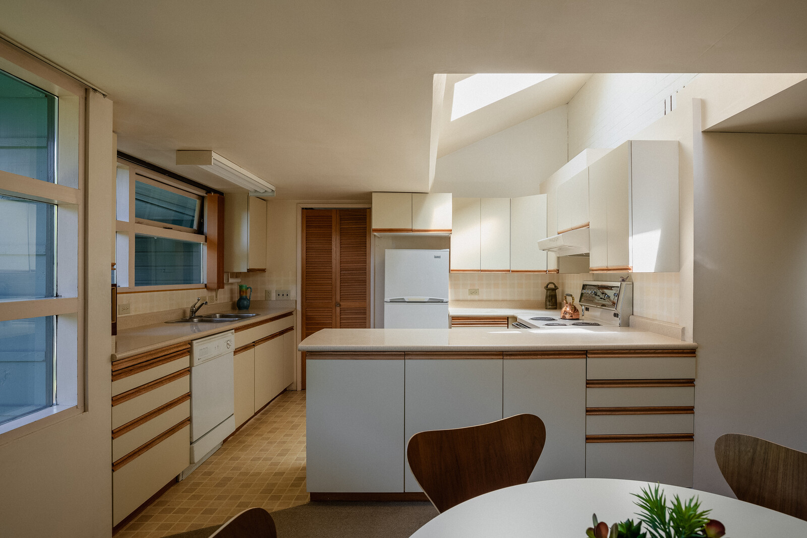 In addition to being bathed with natural light, the corner kitchen is fitted with an abundance of cabinetry and counter-space.