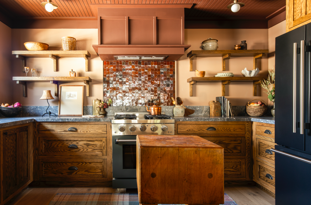 The warm, earth tones in the kitchen complements the home's rich material palette, ranging from the original red brick to breccia antica marble.