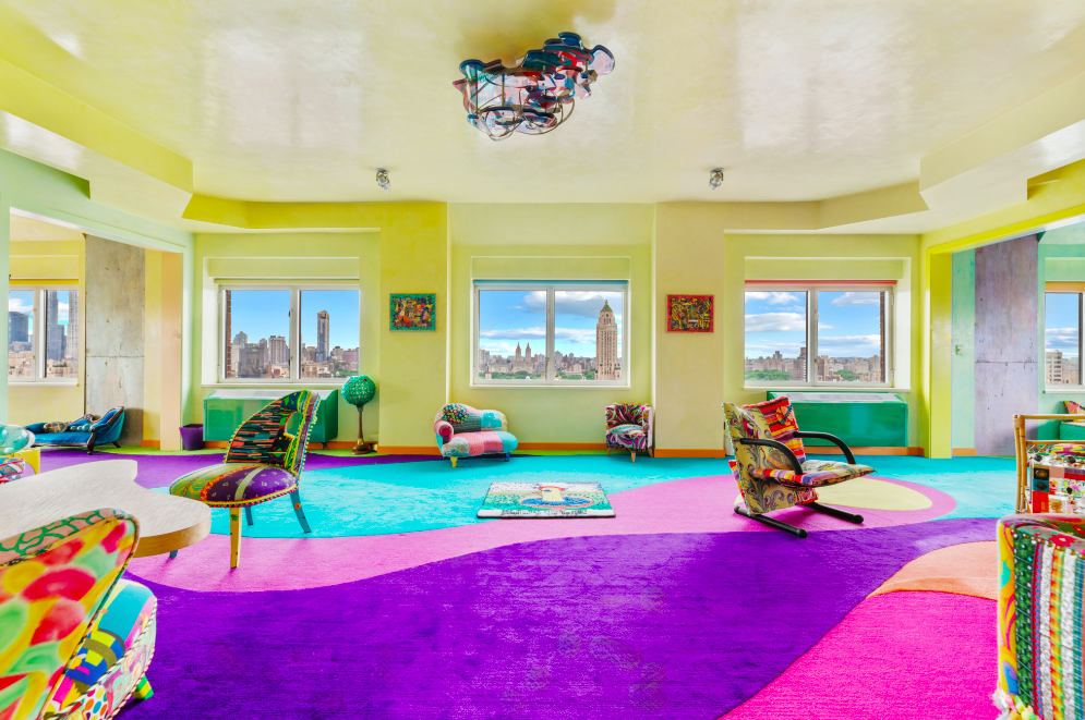 A large entry gallery leads to an expansive entertaining space where picture windows frame views of Central Park and the city beyond.
