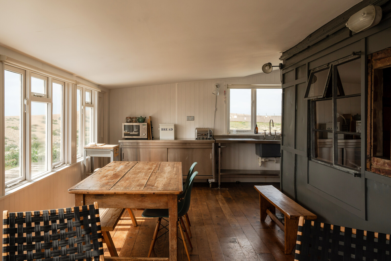 Part of the main living area is sat within the well-preserved railway carriage, while the outer portion is lined with expansive picture windows overlooking the surrounding coastline.