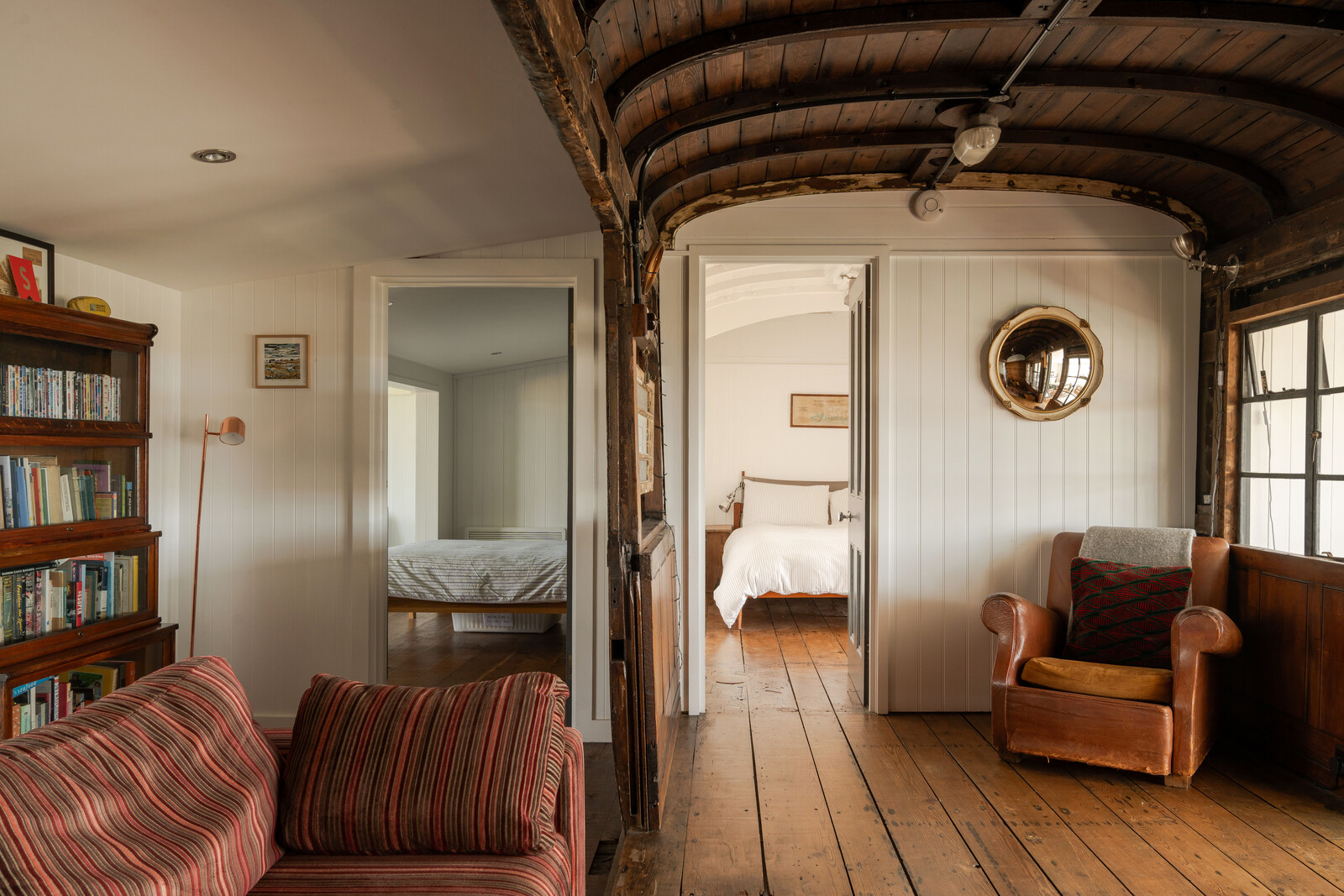 Wide hardwoods line the floors throughout, uniting the various living spaces and bedrooms.