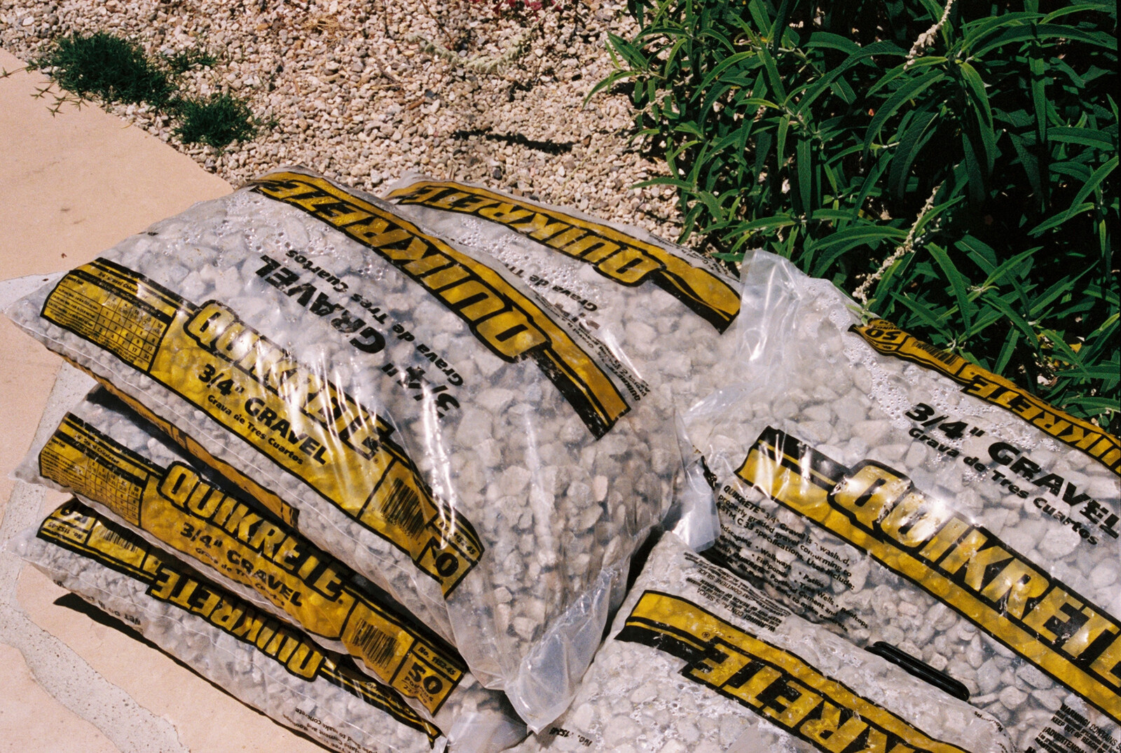I used three-quarter-inch gravel to fill the drainage pit, packing it down with a tamper tool.
