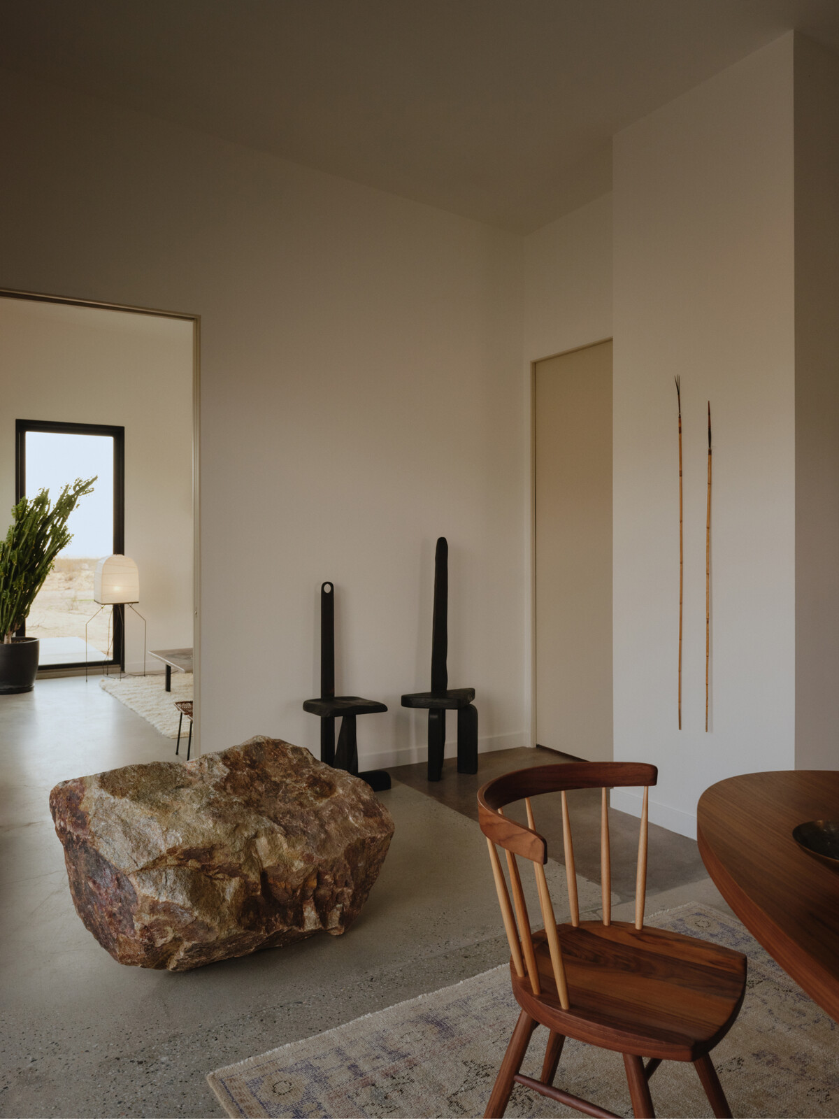 A found boulder sits beside chairs by artist Samuel Richard Hess.