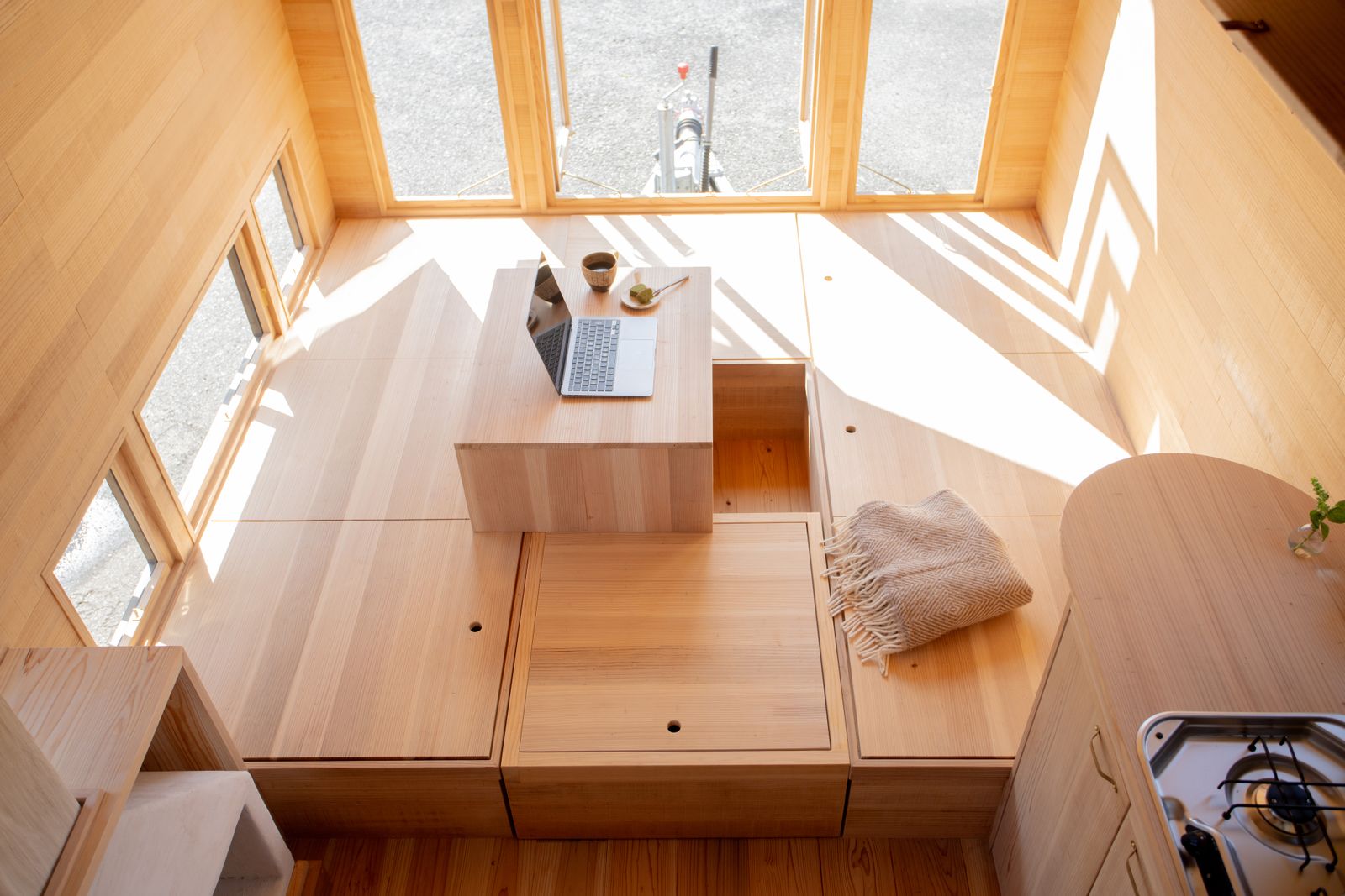 Made from cedar, the raised sitting area doubles as compartmentalized storage.