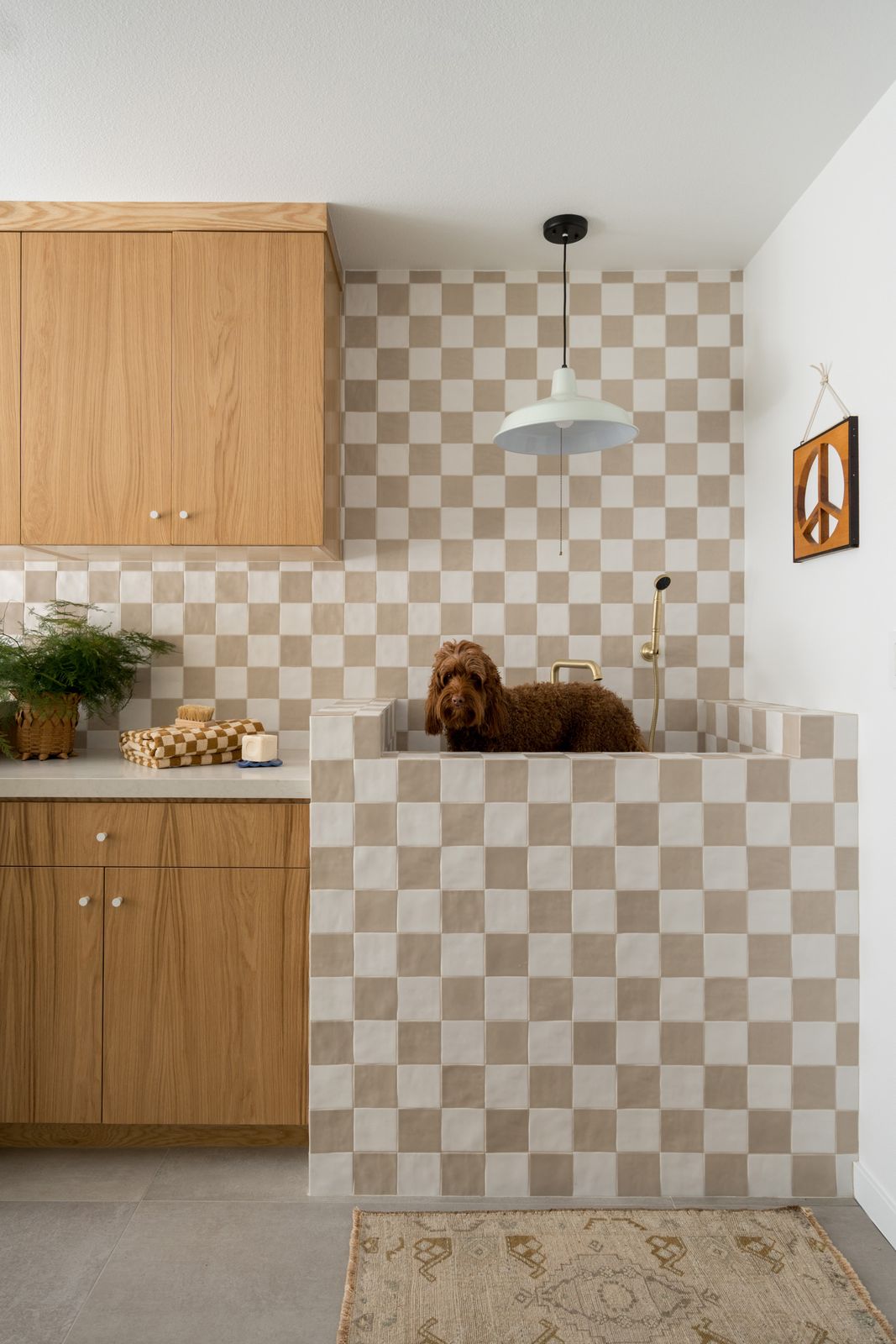 For a couple with three young sons and a dog living in Canyon Lake, California, Popix Designs founder Lizzie Green laid out a grid of ceramic tiles in a checkered pattern that matches the home renovation’s playful ’70s vibe.
