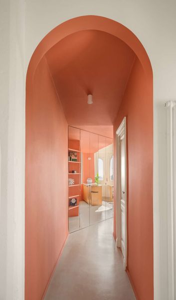 The mirrored wall takes advantage of south facing windows in the living space and reflects light back through the hallway.