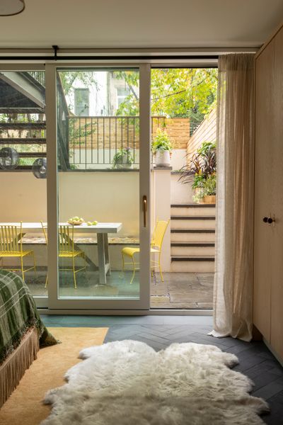 A view from the guest bedroom into the sunken outdoor entertaining space, where the stained-glass bench takes pride of place.
