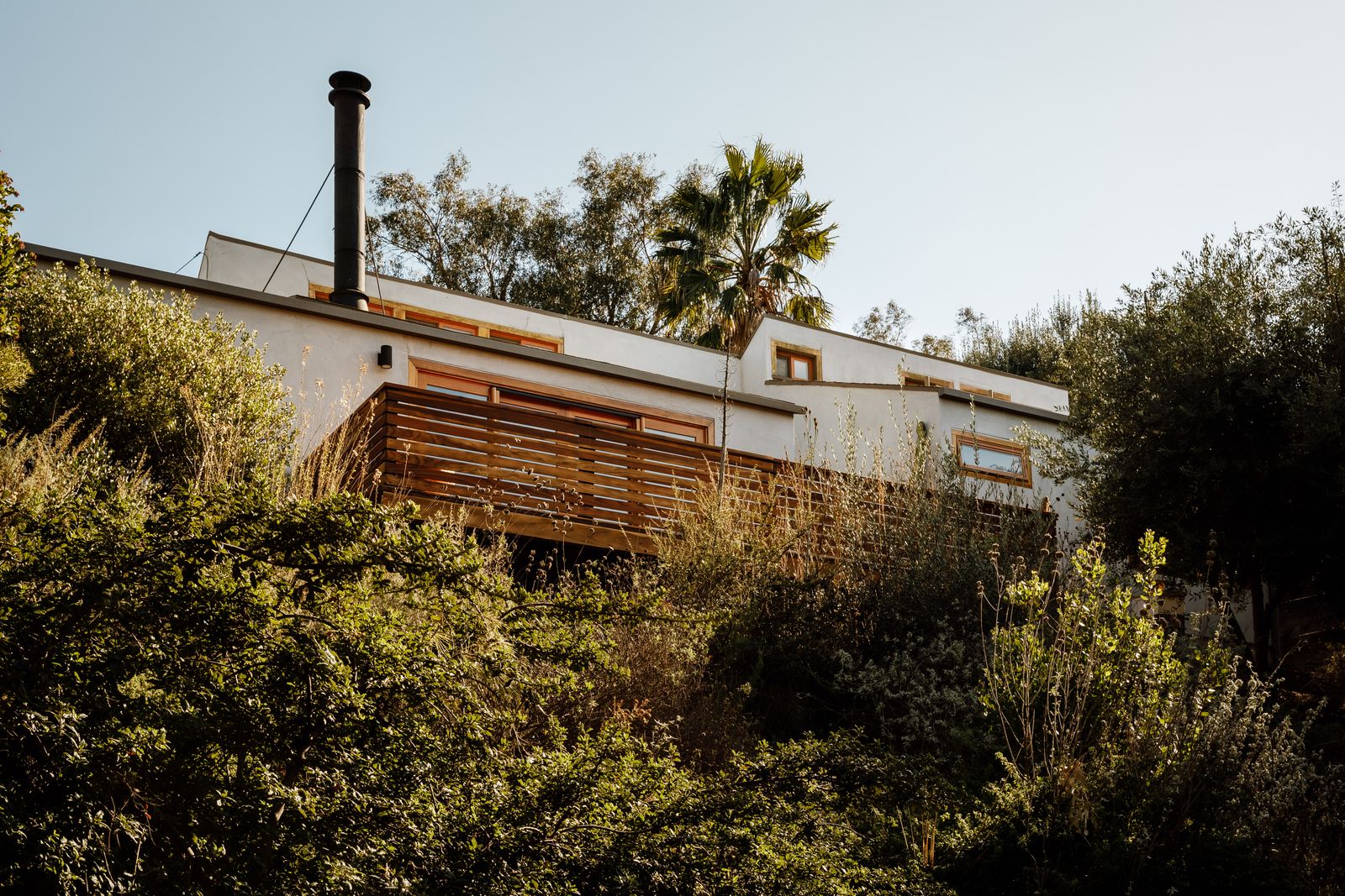Set high on a hilltop, this updated two-bedroom house has a sprawling deck with an outdoor shower and a barrel sauna.