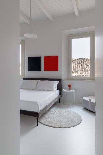 The main bedroom reflects the apartment’s pared-back palette— soft contemporary, and designed for rest. Minimal detailing lets the hillside views take center stage.