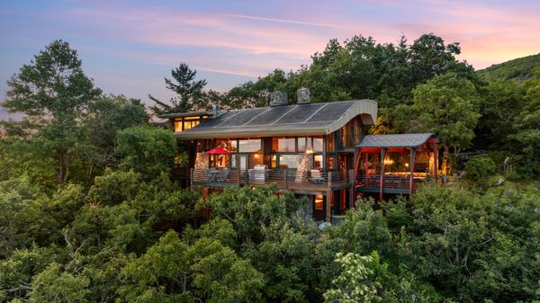 Frank Lloyd Wright protégé Jim Fox used wood, glass and stone to build the monumental residence in the Blue Ridge Mountains. 
