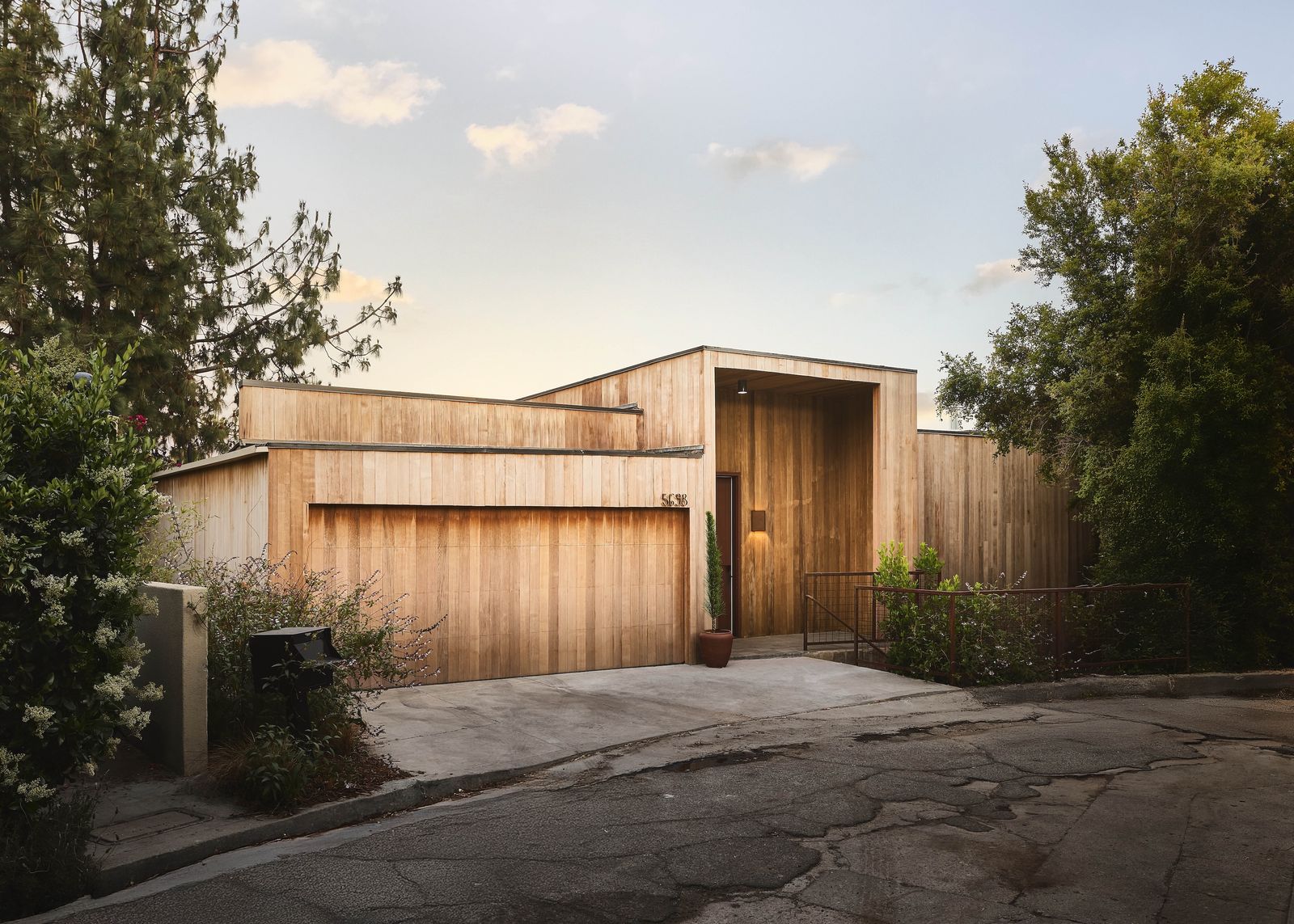 Drawing inspiration from the legendary coastal community, Rubin Studios clad the hillside home in cedar and revamped its interiors with timber, stone, and tile.
