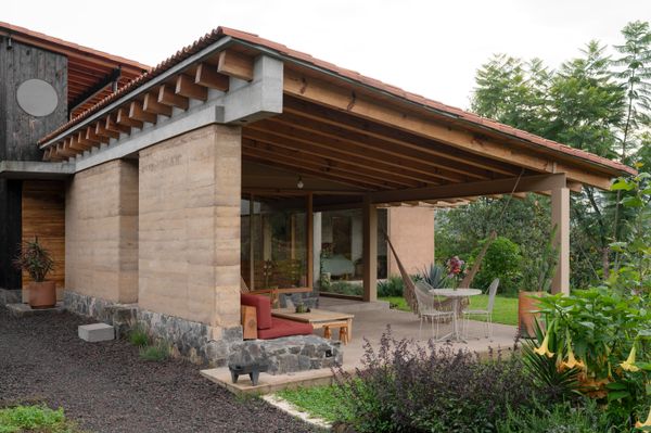 Designed by Luis, the house flows openly to the outdoors. Materials on the roof include concrete, flat clay tiles, curved terra-cotta tiles, steel, and glass. 