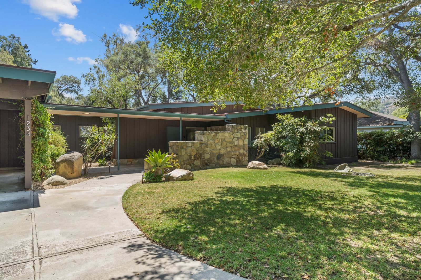 Nestled between Santa Barbara and Los Angeles, this 1957 home has well-preserved woodwork, vintage tile, and natural stone walls.