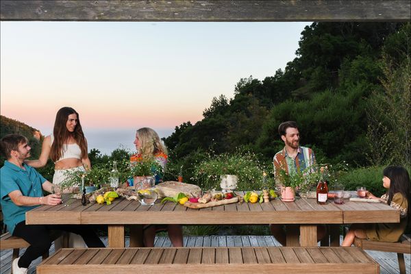 A few of the owners gather at the main house around a table and seating from West Elm.