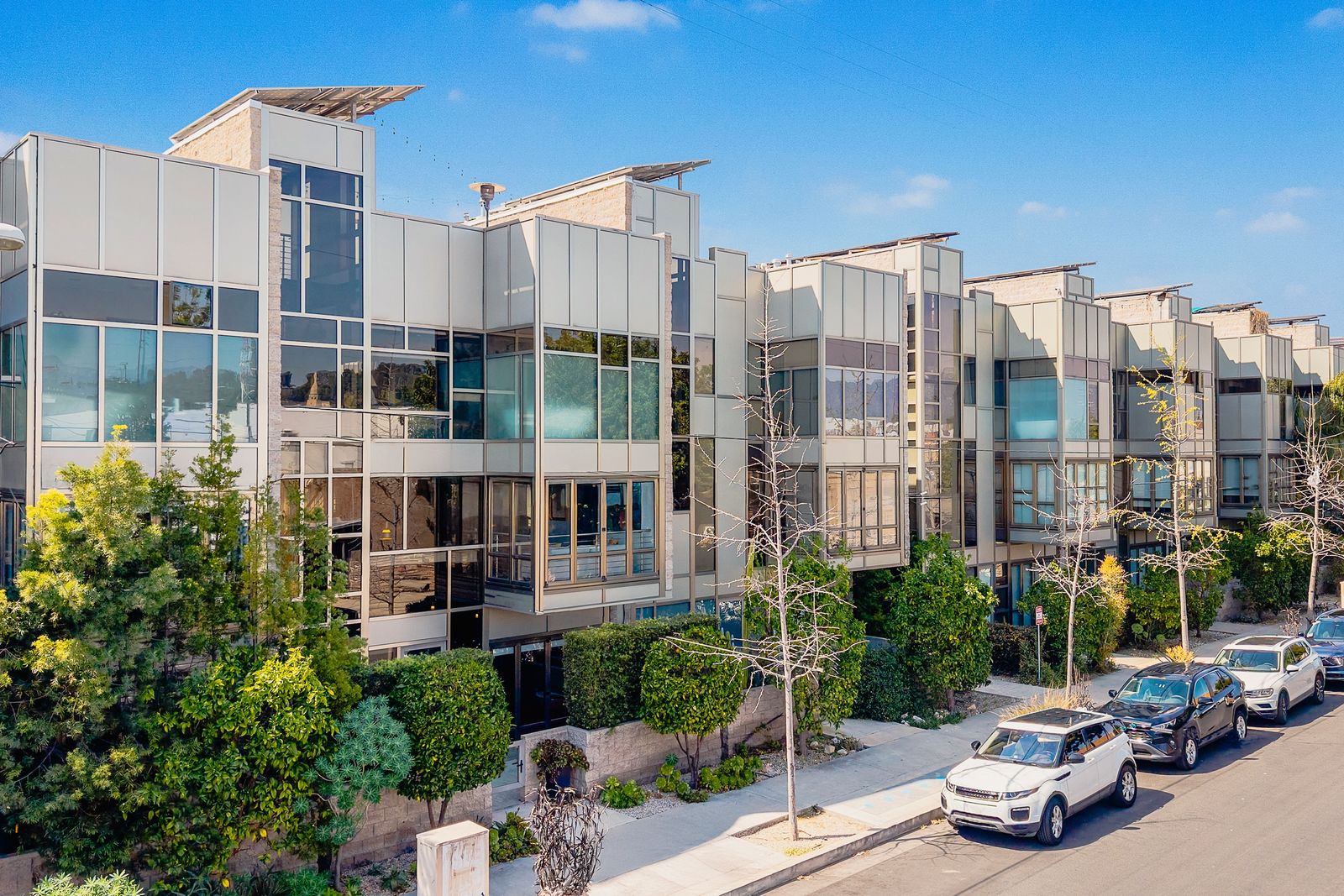 Showcased in the Dwell on Design Home Tours, this Atwater Crossing residence is clad in glass and metal and topped with solar panels.
