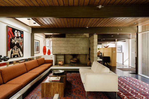 The concrete fireplace separates the kitchen and living room,