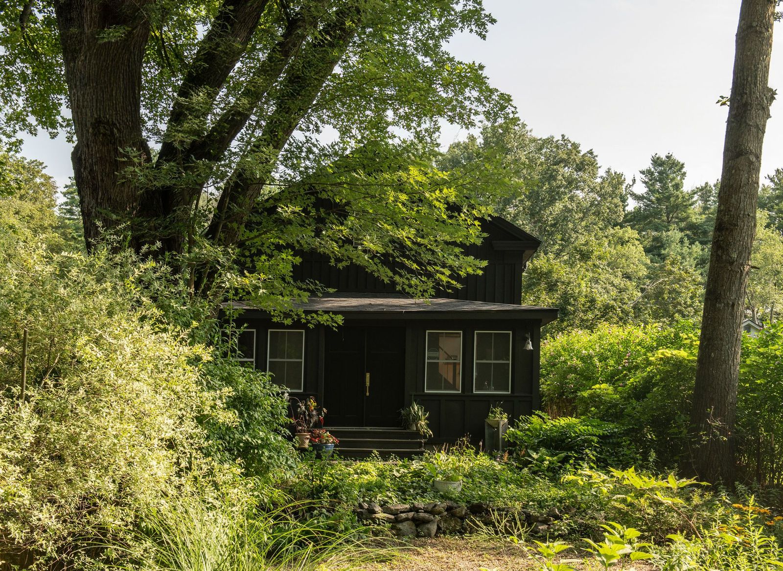 The 1875 structure sits on half an acre with a detached office, a backyard kitchen, and plenty of outdoor living space.