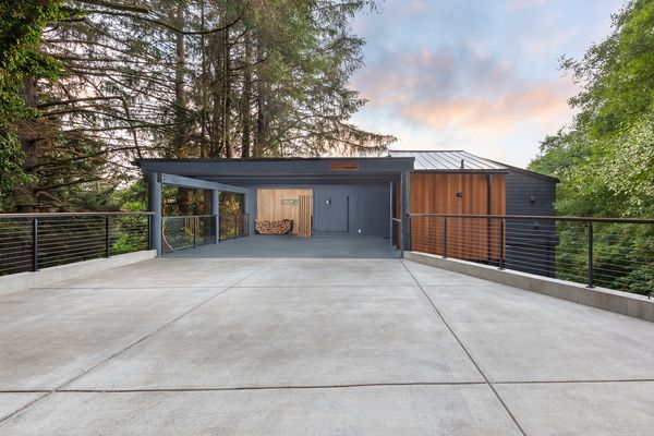 The renovated home has new flooring, fresh interior and exterior paint, a new metal roof, and a freshly poured driveway.