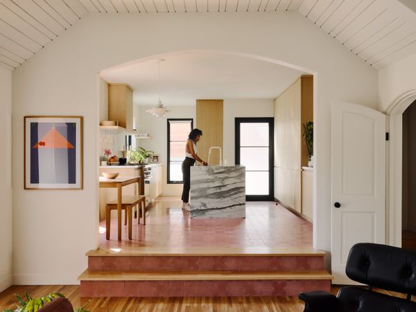 Nicole Boone stands in the kitchen of her renovated ranch house in the View Park section of Los Angeles. A finance executive with an eye for art and design, Nicole enlisted the help of Max Kuo and Danielle Wagner of architectural studio AllThatIsSolid to open up the home’s 1920s layout and bring her love of art, color, and nature to the 1,563-square-foot space. Like many ranches in the hilly neighborhood, the house steps gently down the street, creating three interior levels.