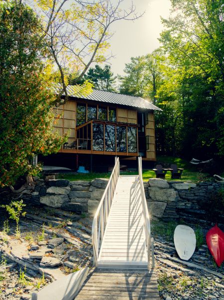 Plywood mega-shingles cover much of the facade, and large windows let in views on the lake side.