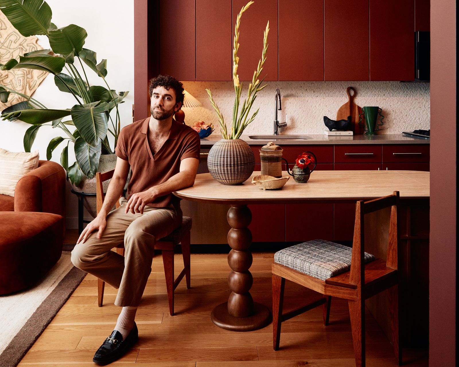 Actor and designer Krysta Rodriguez brought in vintage furniture, warm tones, and a faux fireplace to help her longtime friend Adam Levy bounce back from a breakup.