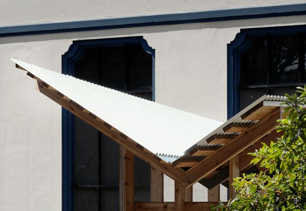The dramatic butterfly roof is striking and visible from a distance—ideally enough so that curious onlookers can walk over to the schoolyard and take a peek.
