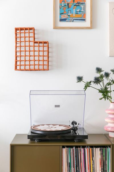 The ceramic wall sculpture hanging above the sideboard is by Akiko Mori, from her Grid series.