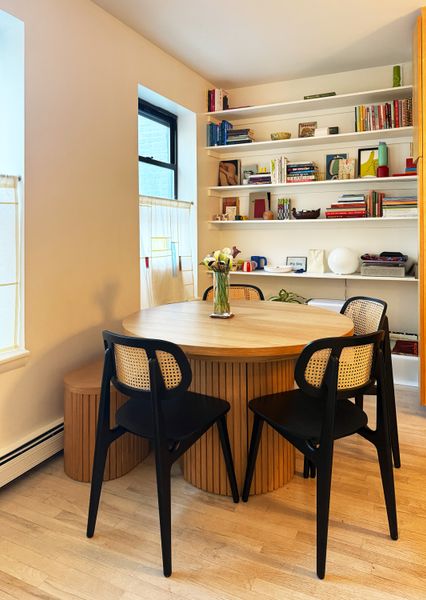 The double-shelf storage cabinets built into two sides of the fluted base is an extra small-space-friendly feature of the Transformer Round dining table.
