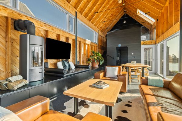 A Stûv wooden stove aids in heating the living room.