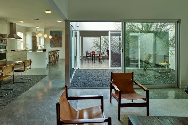 The courtyards are similar in size, form, and materials to the rooms of the house.