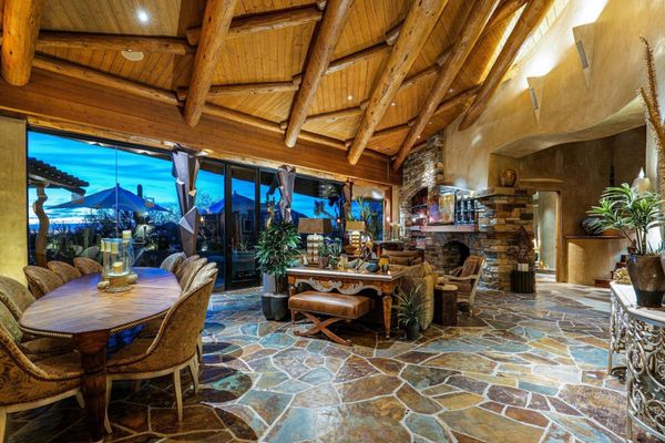 In the great room, exposed log rafters run the length of the ceiling.