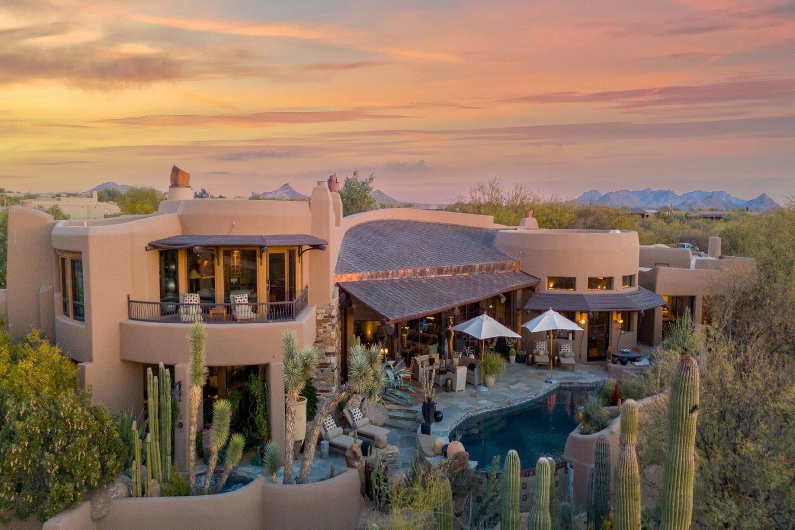 Crafted from stone wood and glass, this sprawling home has curvaceous interiors and an abundance of fireplaces.