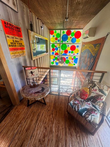 A seating area on the upper level overlooks the double-height living room.